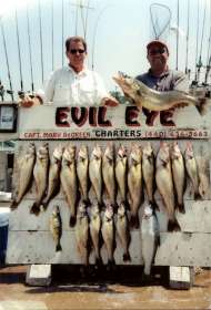 Back at the dock, two guys show off their catch of walleye along with a steelhead and a large perch.