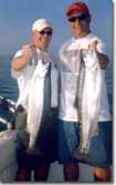 Two guys pose with the steelhead they each caught.