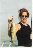 Lady holds up a huge jumbo Perch for the camera.